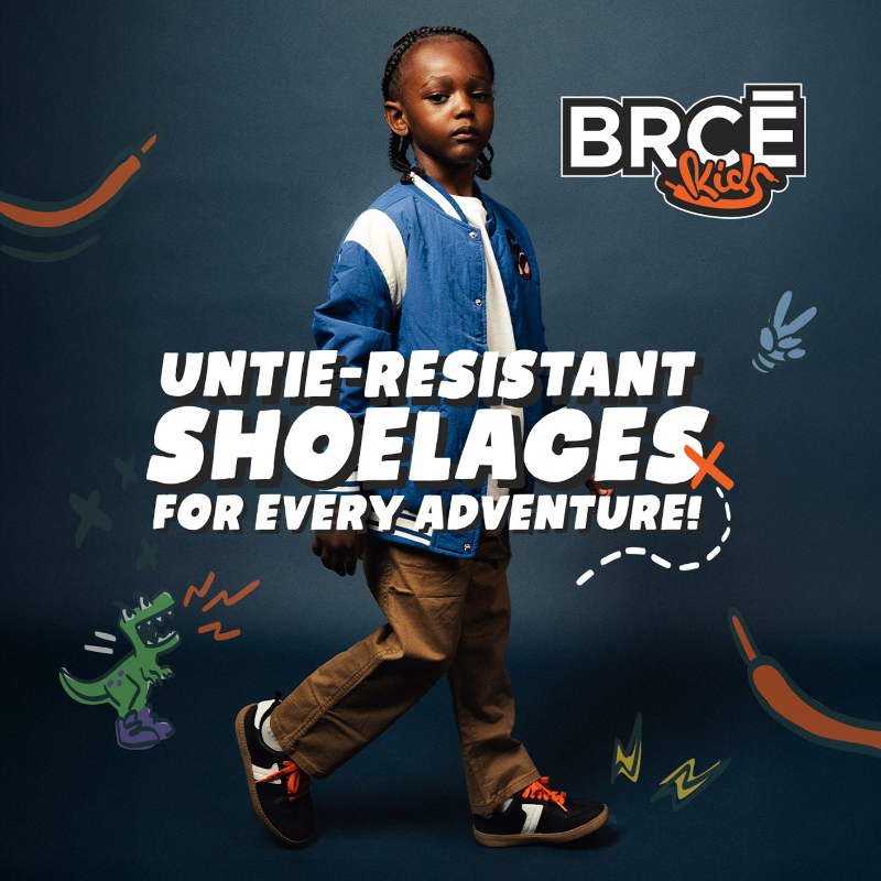 A photo of a young African American boy sporting BRCE Kids Laces on his black tennis shoes.